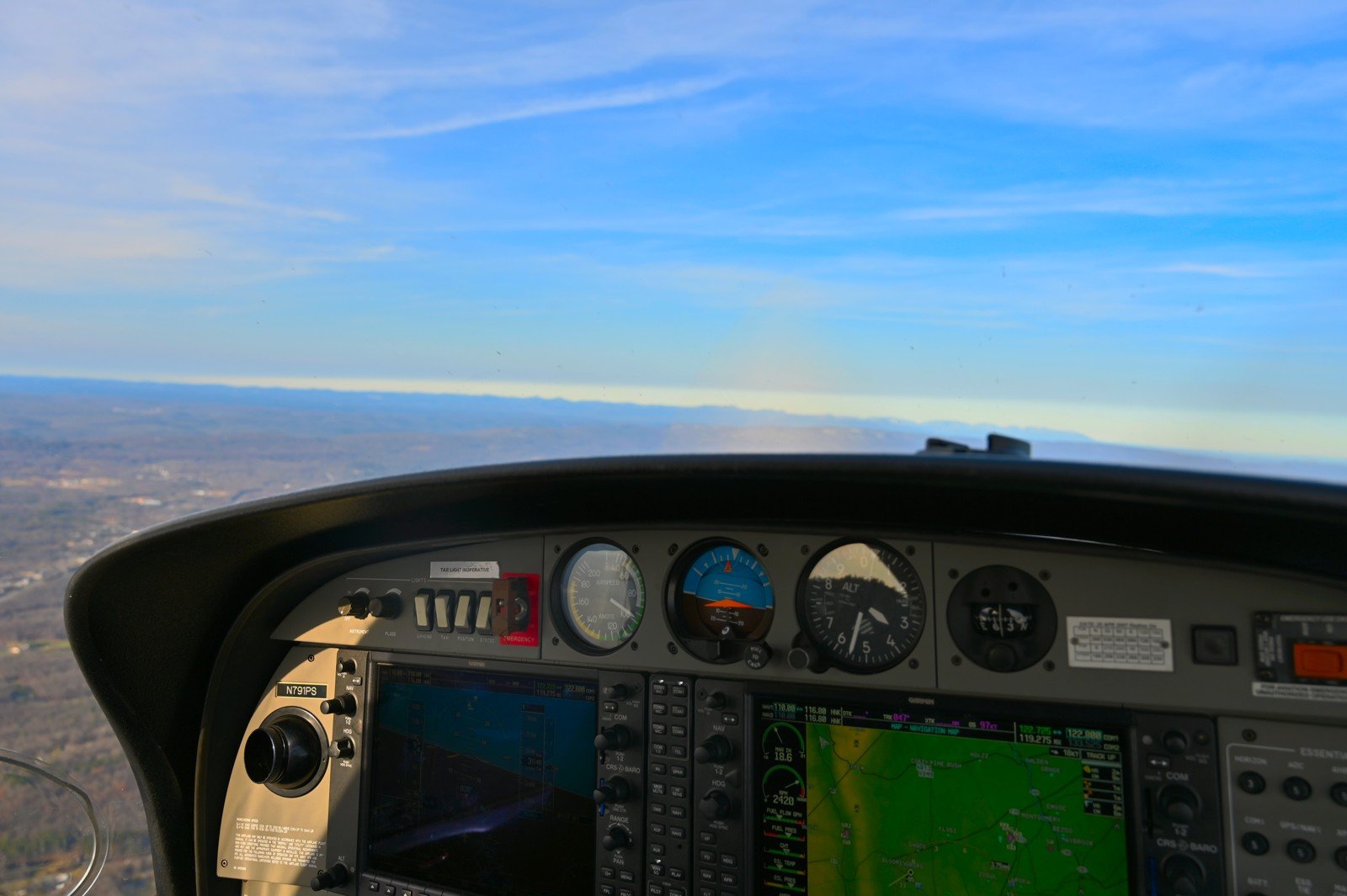 Glass-cockpit panel with a wide horizon and blue sky ahead