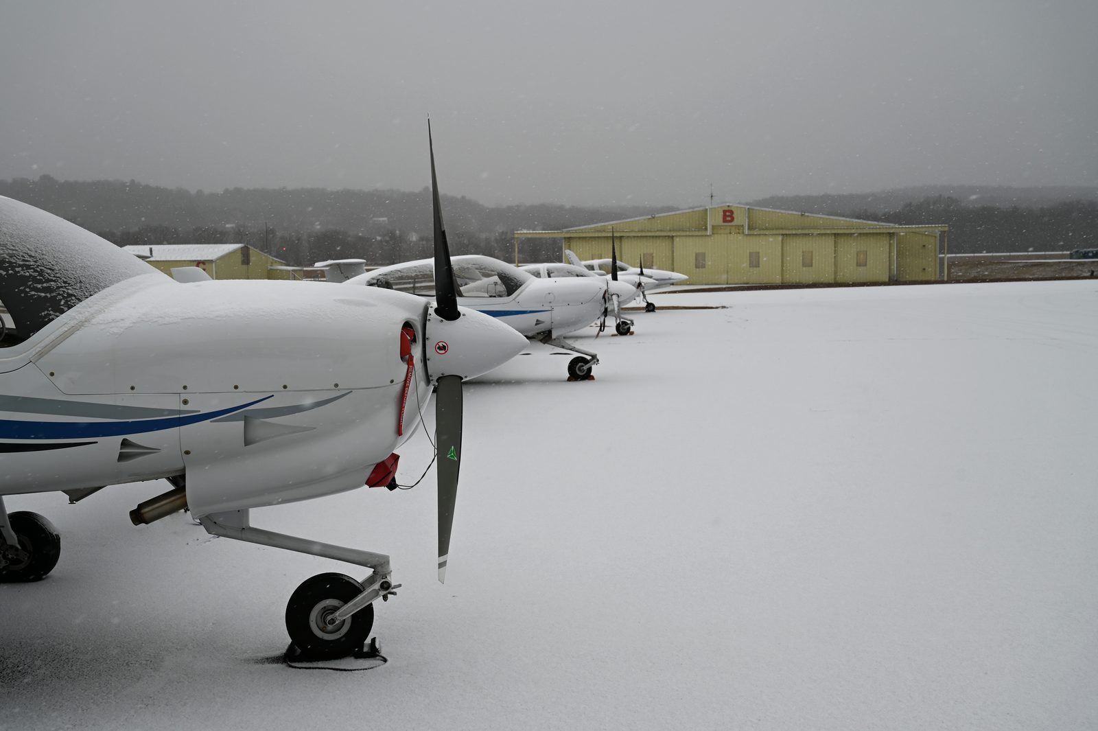 Diamond aircraft nose and propeller on a snow-covered ramp
