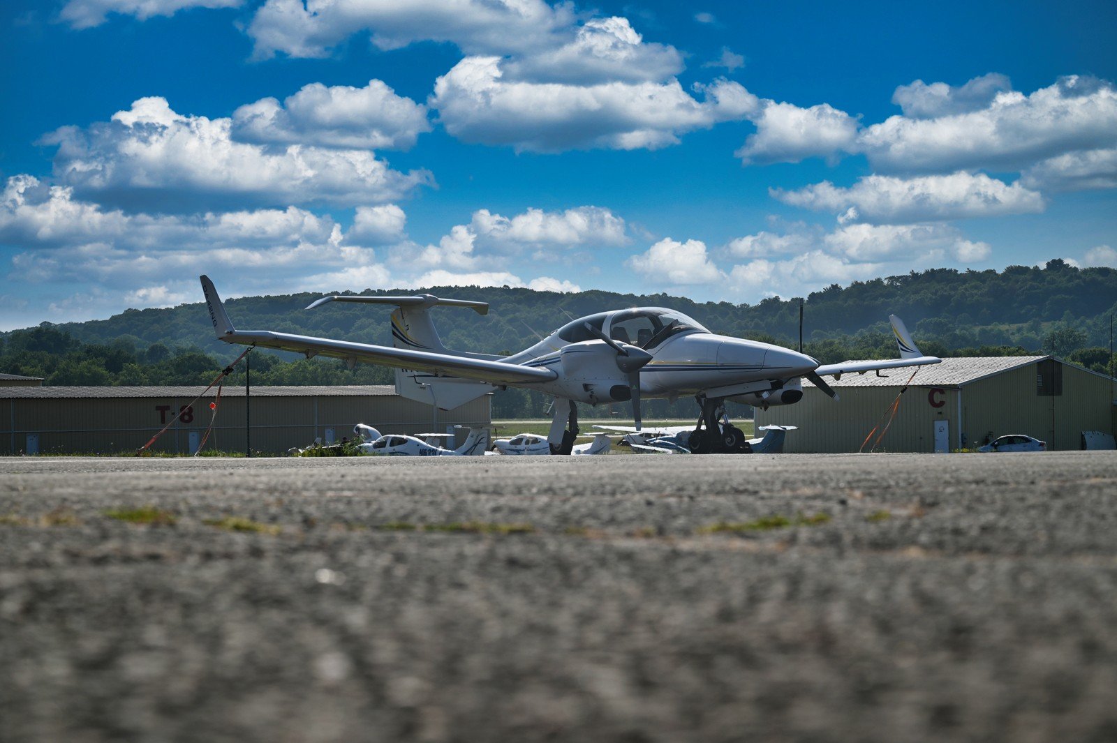 Diamond twin on the ramp with green hills and clouds behind