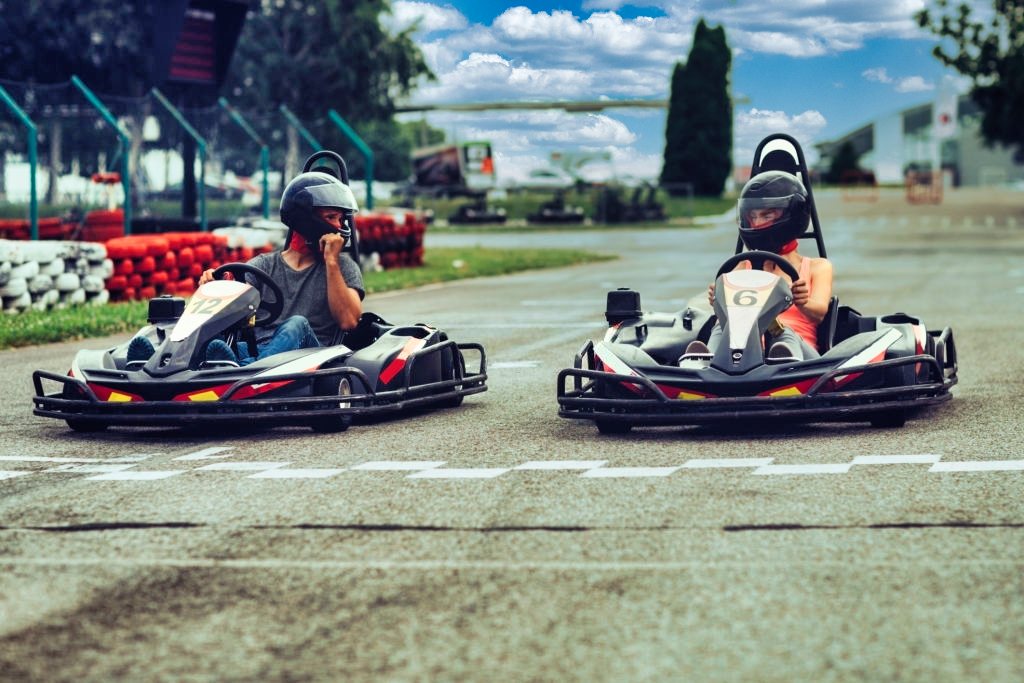 Mother and father go-Karts together. Driving from start position on driveway